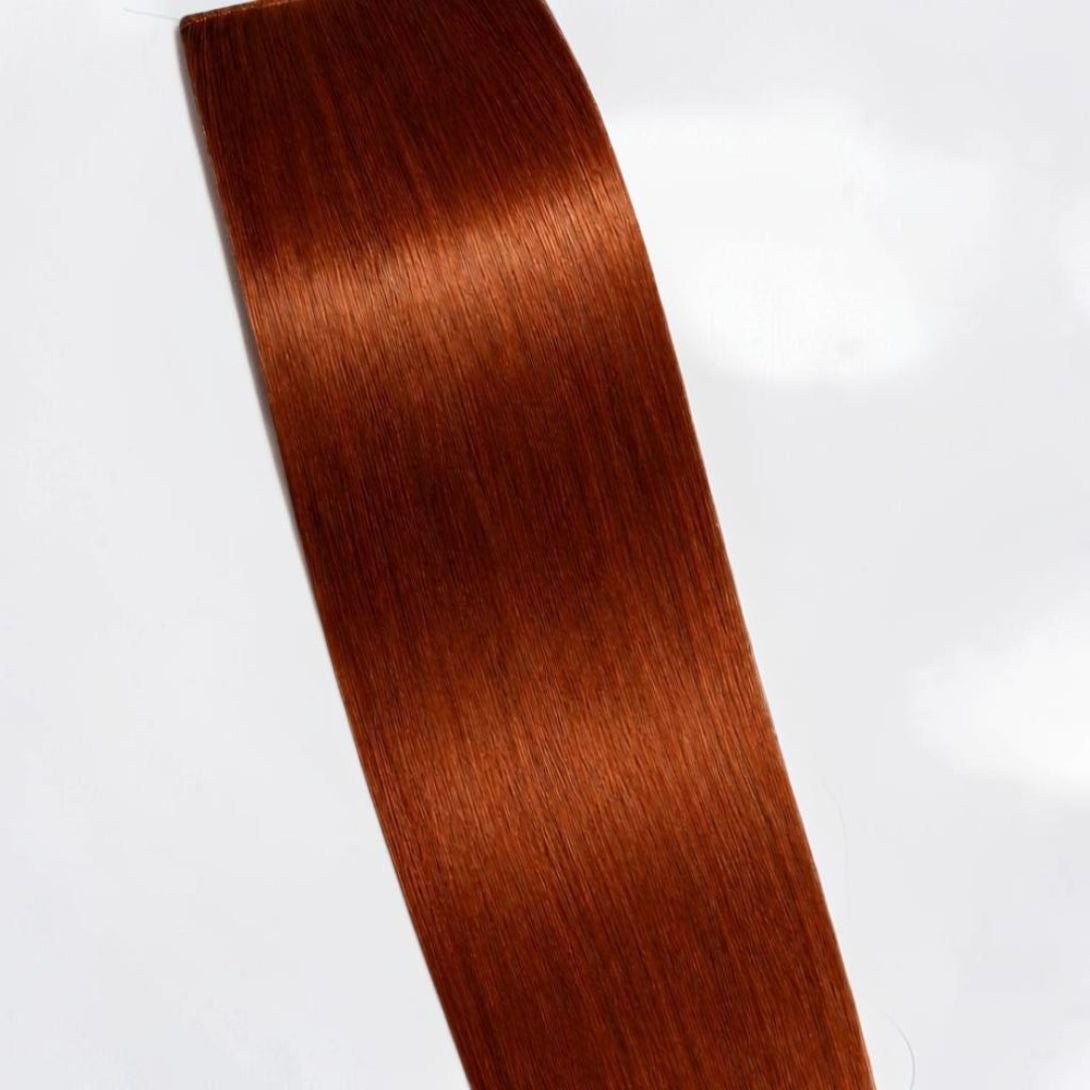 Ginger copper human hair ponytail extension in a warm red copper shade