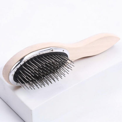 Detangling brush for hair extensions with a wooden handle displayed on a clean light marble surface