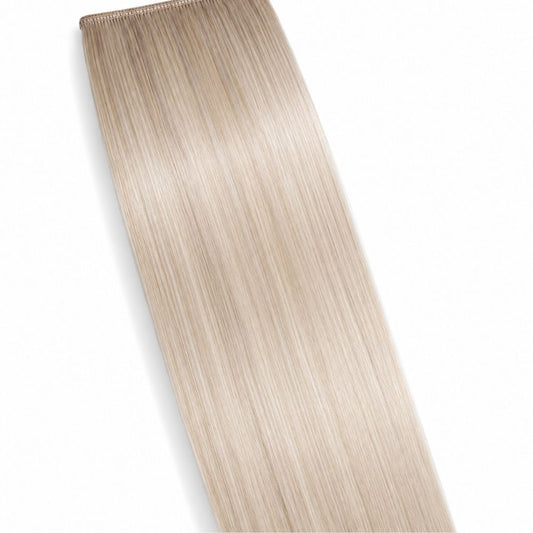 An Ice Blonde ponytail hair extension displayed on a clean white background, showing its smooth Remy Human Hair texture.