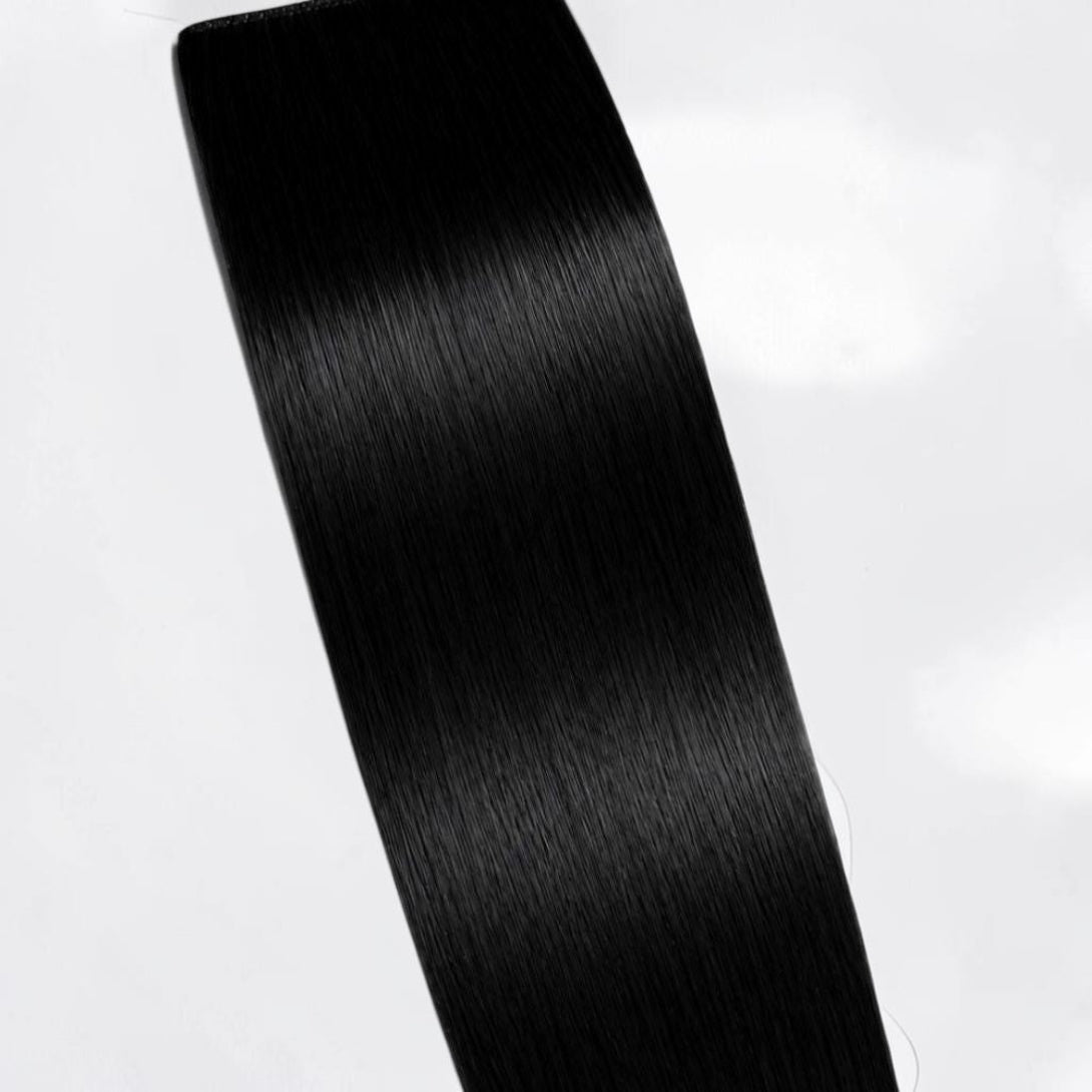 Jet black human hair ponytail extension in a deep natural black shade