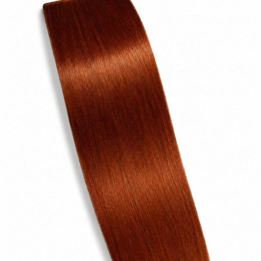A Copper ponytail hair extension displayed on a clean white background, showing its smooth Remy Human Hair texture.