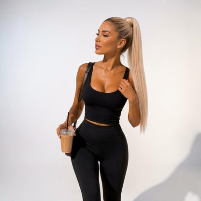 A model wearing a Vanilla Blonde high ponytail extension, showing the natural finish and sleek length.