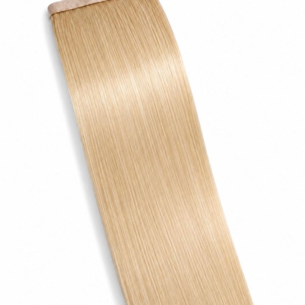A Vanilla Blonde ponytail hair extension displayed on a clean white background, showing its smooth Remy Human Hair texture.